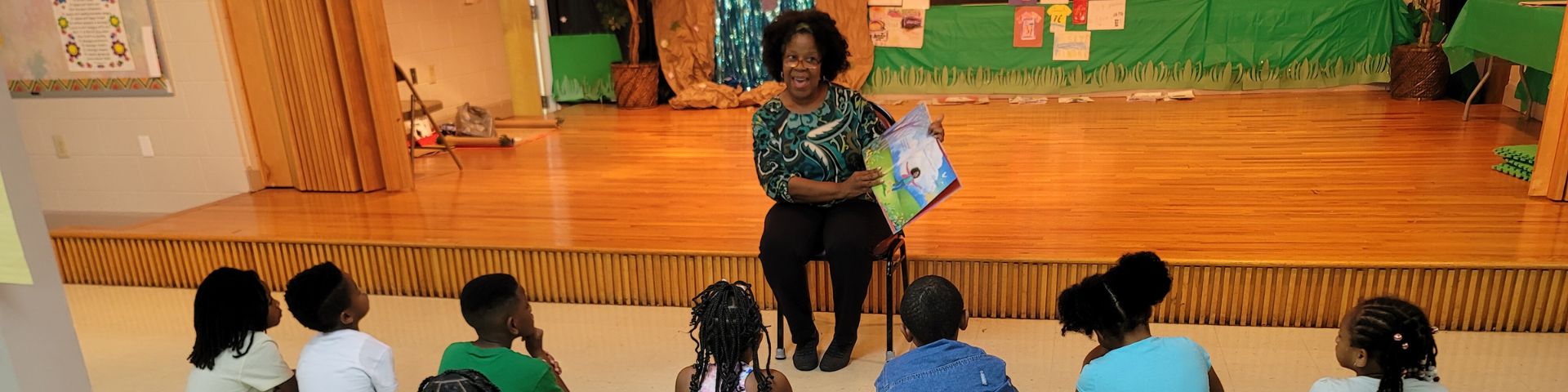 Guest reader reading to freedom school scholars